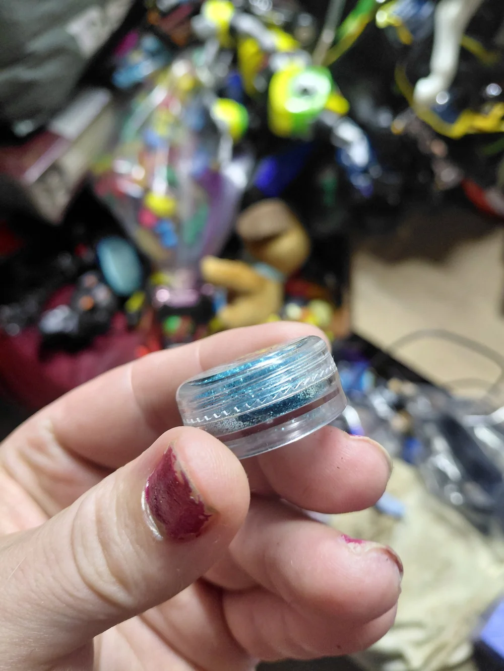 small, round container of blue-toned body glitter featuring Minions on lid .07oz